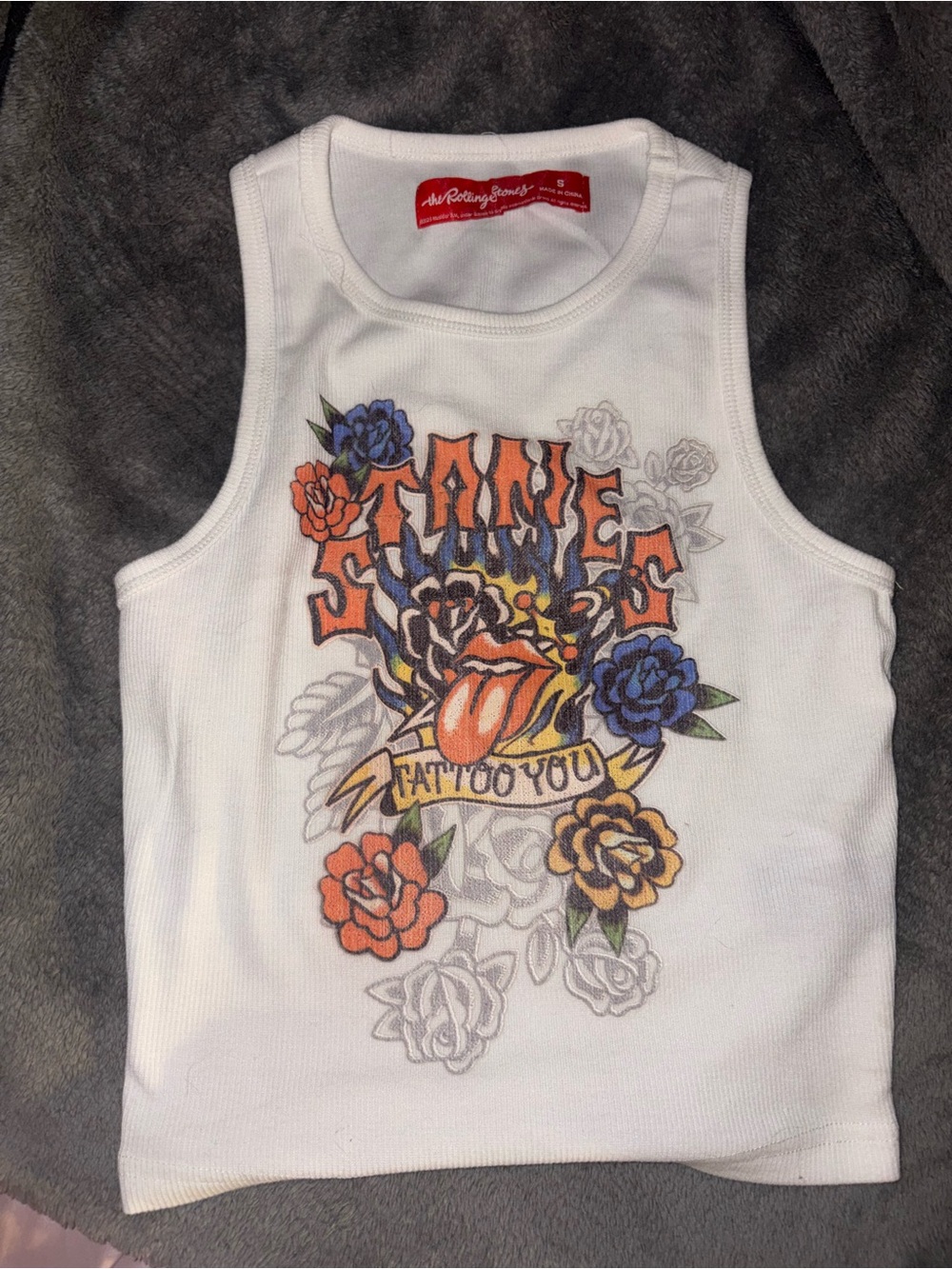 the Rolling Stones White Ribbed Crop Tank with Tattoo-Style Floral Graphic